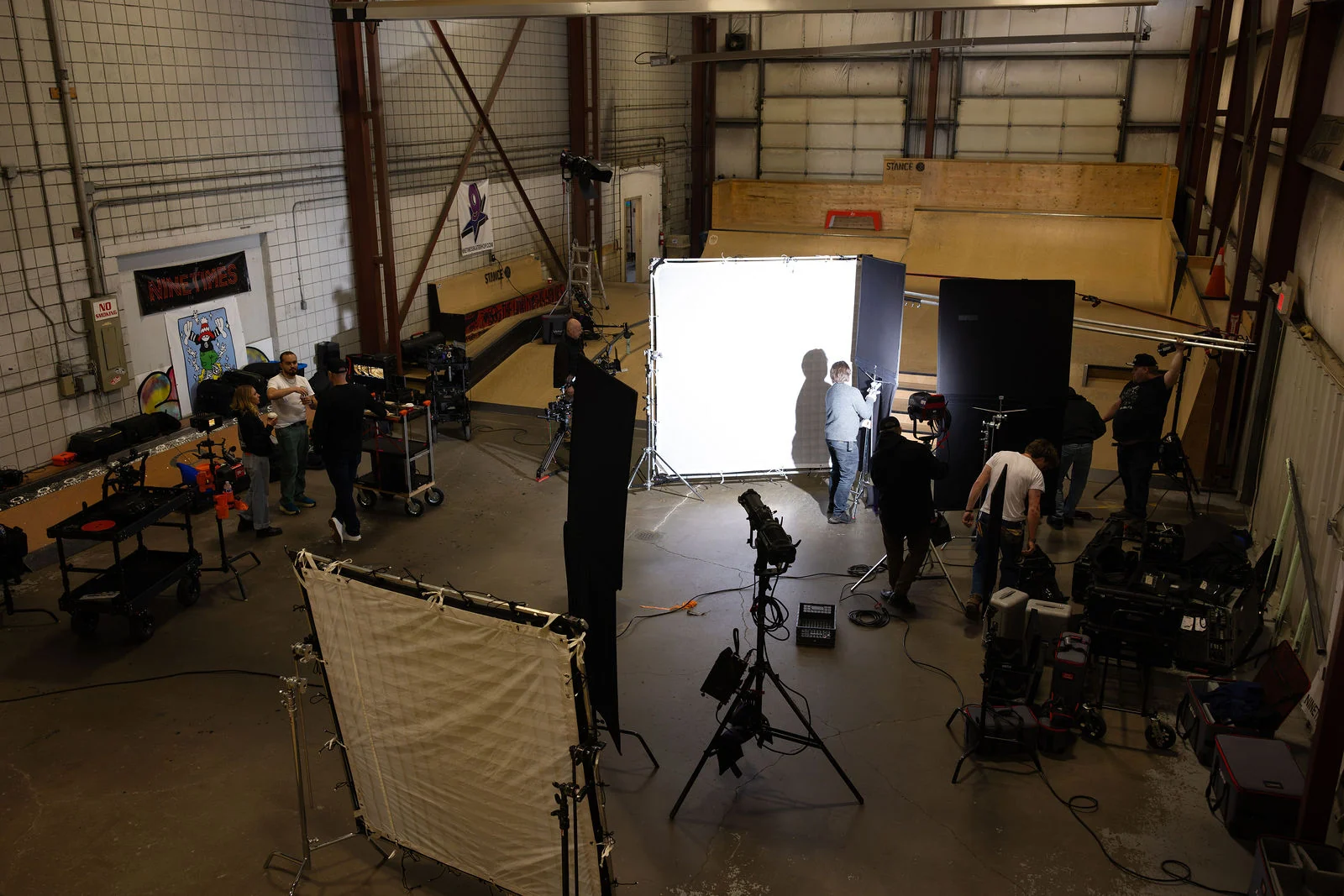 Wide production setup with cameras, crew and large lighting frames for Gift of the Game